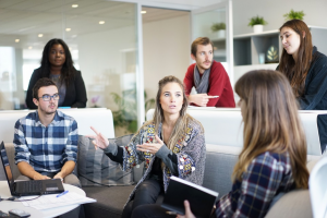 a group of people talking indoors